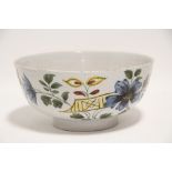 AN 18th century LIVERPOOL POLYCHROME DELFT BOWL painted with flowers in the Fazackerly palette;