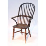 A Victorian ash & elm Windsor elbow chair with hooped spindle back, hard seat, & on turned legs with