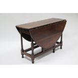 An 18th century oak oval gate-leg table fitted end drawer, on slender turned tapered supports with