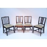 A matched set of four George III mahogany rail-back dining chairs with padded needlework drop-in