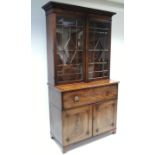 A Regency mahogany secretaire bookcase with three adjustable shelves enclosed by a pair of glazed