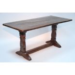 An early 18th century style oak refectory table on shaped end supports; 60" x 28".