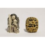 A Japanese carved ivory netsuke in the form of a standing witch holding a skull, signed, 2"