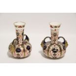 A pair of Royal Crown Derby porcelain “Imari” squat round vases with tall narrow necks & mask side