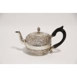 A late 19th/early 20th century Indian teapot of compressed round form, with removable lid,