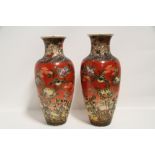 A pair of late 19th century Japanese pottery ovoid vases of rust-red ground, painted with birds &
