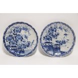 A pair of Japanese blue & white porcelain shallow fluted dishes painted with flowers & birds; 12"