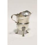 A helmet-shaped cream jug with cut-card rim, scroll handle, & on three lion-mask feet, 3¾" high;