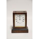 A Victorian mantel timepiece with black roman numerals to the white enamel dial, in plain walnut