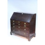 An 18th century mahogany bureau, the sloping fall front enclosing a fitted interior, four long