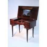 An early 19th century mahogany dressing table, the rectangular rising top enclosing apertures for