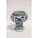 A Chinese blue & white porcelain vase-on-foot painted with a formal floral pattern in the Ming