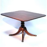 A regency mahogany breakfast table, the rectangular tilt top on baluster-turned centre column & four