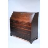 A late 18th century oak bureau, the sloping fall front enclosing fitted interior, above two