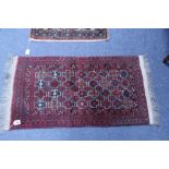 Four small Persian mats.