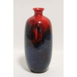 A Royal Doulton “Flambé Veined” slender ovoid vase with short narrow neck, decorated with vivid