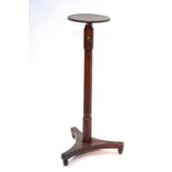 A 19th century mahogany adjustable stand with 9½" diam. top on rise-&-fall column & triform base;