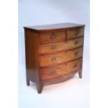 An early 19th century mahogany bow-front chest fitted two short & three long graduated drawers