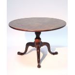An 18th century mahogany tripod table with circular tilt top, on three cabriole legs with pad