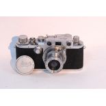 A VINTAGE LEICA CAMERA (No. 483396) with Leitz Elmar 1:3, 5 lens & with leather case.