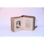 A VICTORIAN SMALL LEATHER-BOUND PHOTOGRAPH ALBUM CONTAINING FIFTY BLACK & WHITE CARTE-DE-VISITE