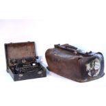 A tan leather Gladstone-type bag, 21" long; and a Corona “No. 3” portable typewriter with case.