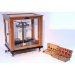 A brass Microid Analytical model laboratory balance, with weights & in glazed case.