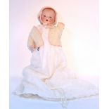 An Armand Marseille bisque-head baby doll (A.M. Germany 351/3K) with blue open eyes, open mouth, and