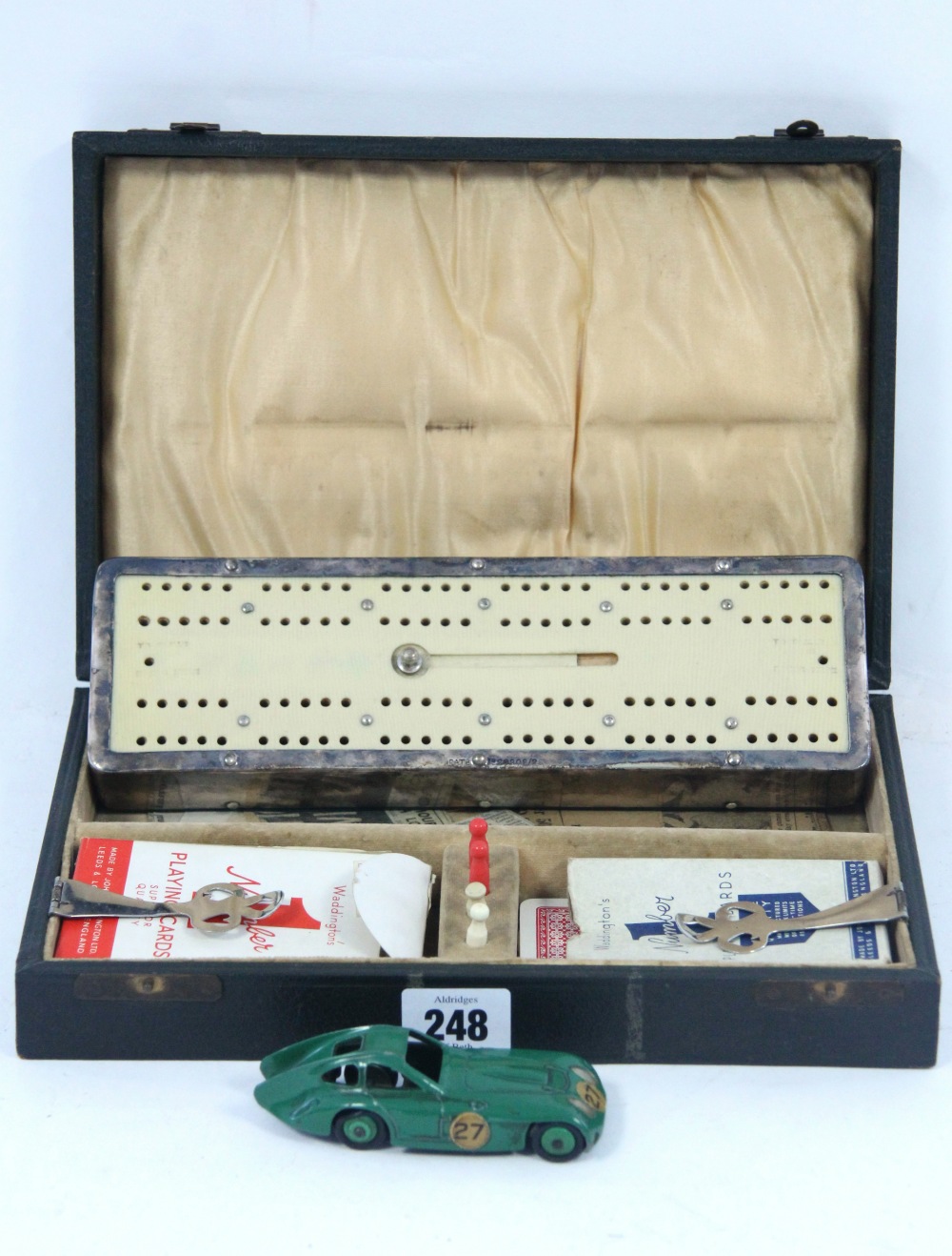 A Dinky die-cast scale model car “Bristol 450” (No. 163), unboxed; and a cribbage board set, cased.