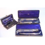 Three cased sets of medical instruments.