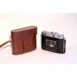 A Balda 35mm folding camera with leather case.