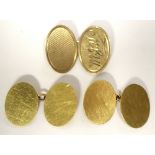 A pair of 18ct gold cuff-links with plain oval panels, Birmingham 1916 (8.2g); & a single 9ct gold