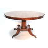 A REGENCY ROSEWOOD CENTRE TABLE, the circular tilt top with gadrooned & beaded rims, on turned
