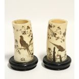 A pair of Japanese ivory tusk vases with shibayama style decoration of blossoming trees, birds, &