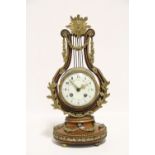 A late 19th century French lyre-shaped mantel clock in mahogany case with cast gilt metal foliate