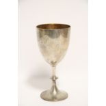 A late Victorian trophy cup with gilt interior to the plain ovoid bowl, on baluster column &