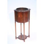 An Edwardian inlaid mahogany jardinière with serpentine sides & brass liner, on slender turned