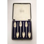 A set of six George V grapefruit spoons with baluster knops & narrow pointed bowls; London 1926-8,