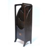 An Edwardian Scottish Art Nouveau oak upright magazine rack of three compartments, with pierced