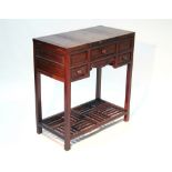 A Chinse hardwood dressing table with rectangular envelope top, fitted hinged mirror, three frieze