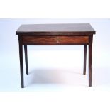 An early 19th century mahogany tea table with rectangular fold-over top above a frieze drawer, on