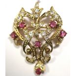 A gold open-work scroll design brooch/pendant set six small rubies & numerous small diamonds.