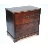 An early 18th century oak chest fitted four long graduated drawers, the original brass handles