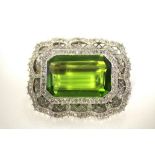 A peridot & diamond brooch, the large rectangular centre stone measuring approx. 20mm x 13mm