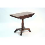 A William IV mahogany tea table with rectangular fold-over top, carved scroll frieze, on turned