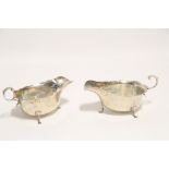 A pair of Edwardian oval sauce boats with cut-card rims, each with open C-scroll handle & on three