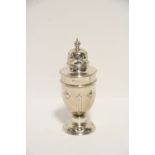 An Edwardian ovoid sugar castor with embossed decoration & on domed foot, 6¾” high; London 1906,
