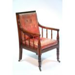 A REGENCY MAHOGANY LIBRARY ELBOW CHAIR with red leather seat & buttoned back, turned spindle