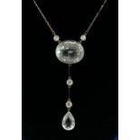 An Aquamarine & diamond pendant, the oval stone measuring approx. 20mm x 16mm, suspended either side