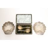 A pair of Victorian fluted shell-shaped butter dishes, each on three ball feet; 4" x 4½", London